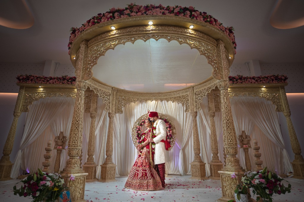Hindu wedding couple portrait at Mandap ceremony during sacred Vivaha rituals